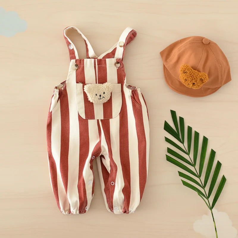 Red striped teddy overall romper laid flat beside a brown hat