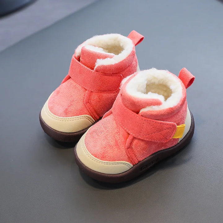 Red suede winter boots with cream plush lining, wide straps, and contrasting beige toe panels