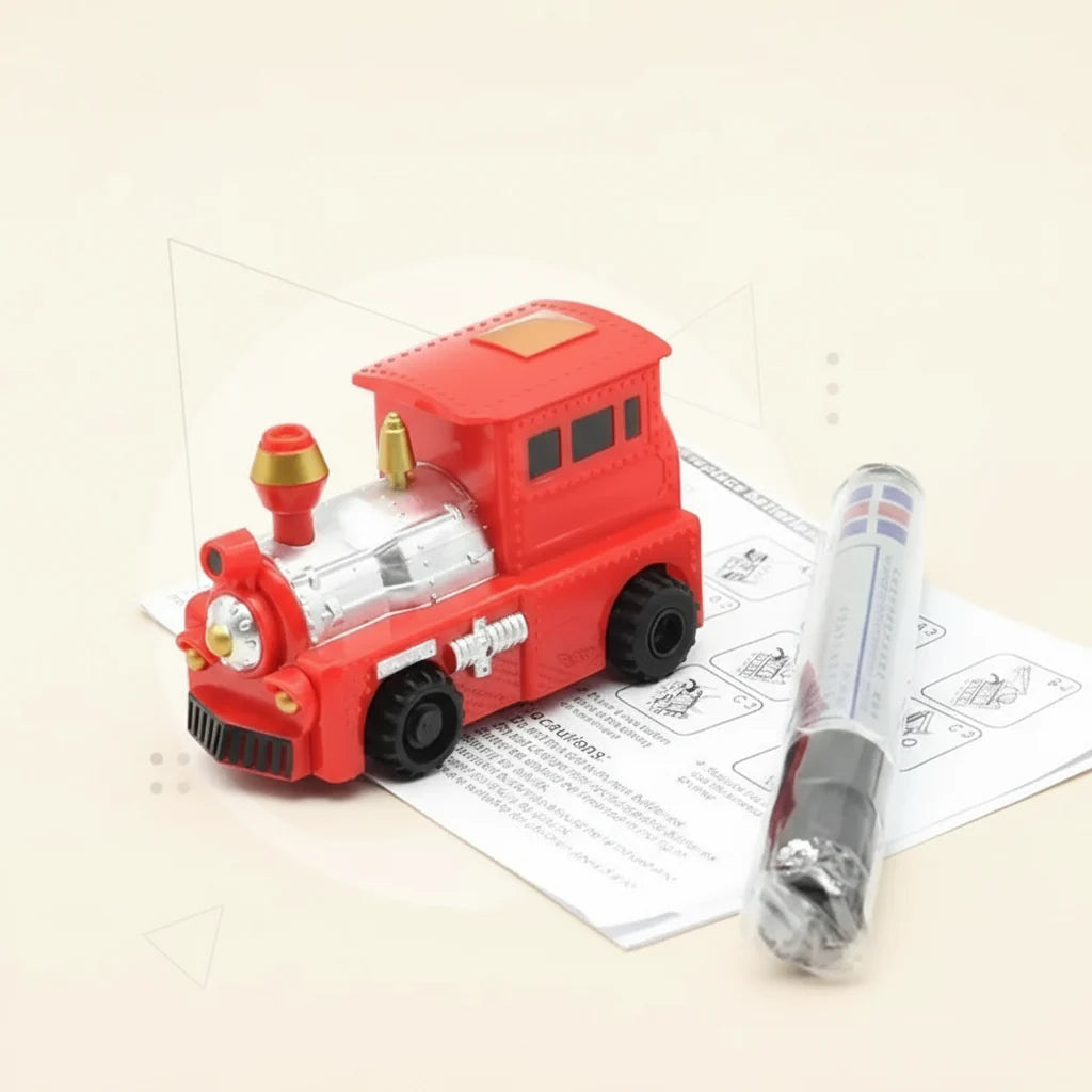 Red toy train with silver details beside a drawing pen and instruction sheet