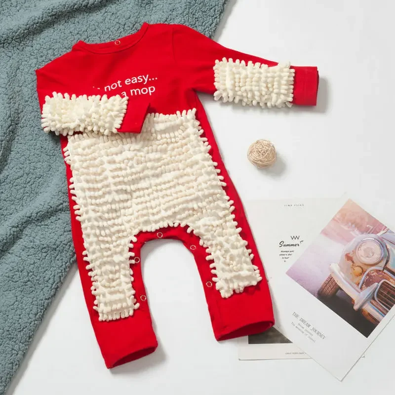 Red baby jumpsuit with white cleaning fibers on the front and sleeves