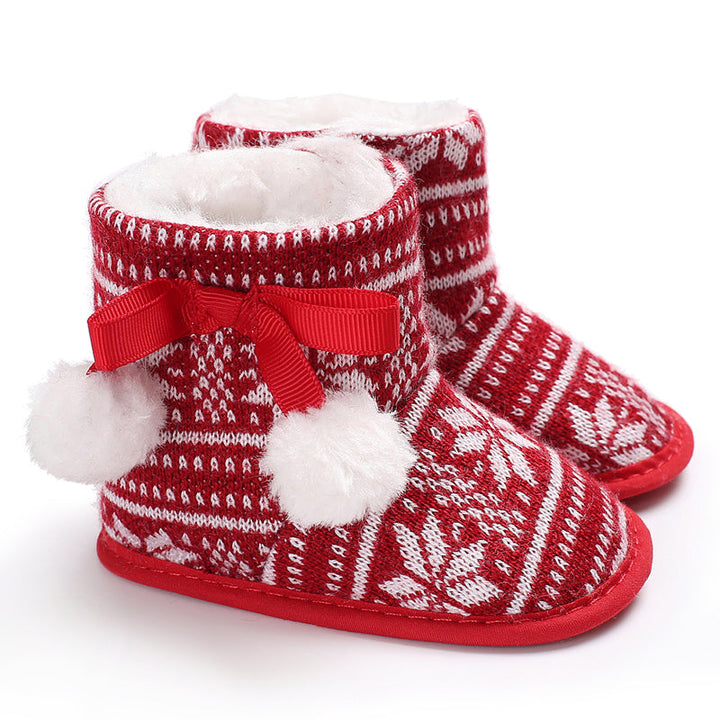 Red and white patterned baby boots with bows, pom-poms and soft white cuffs