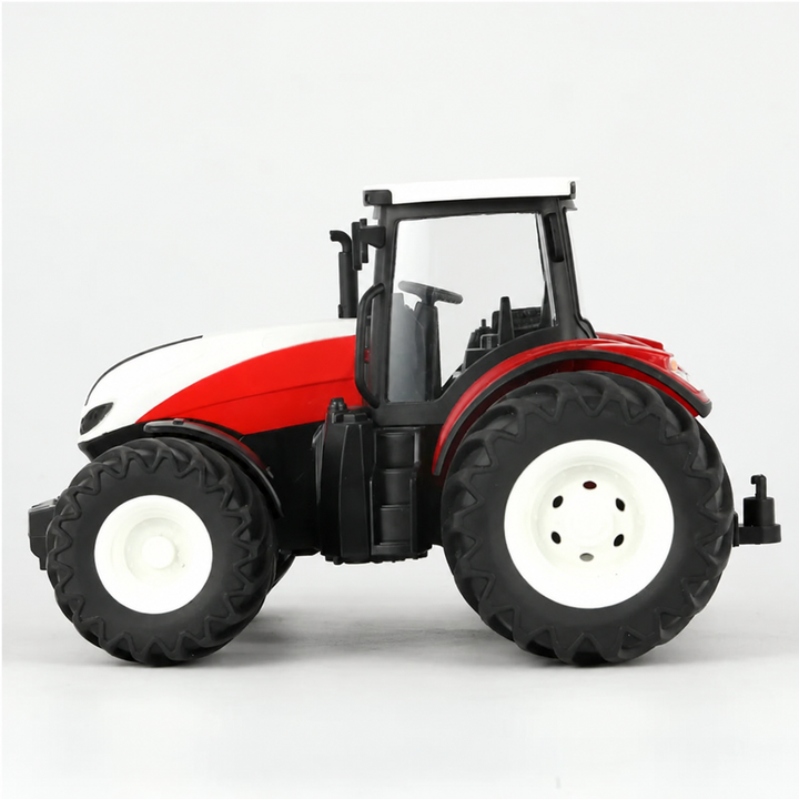 Side view of the red and white RC tractor with large rear wheels and an enclosed cab