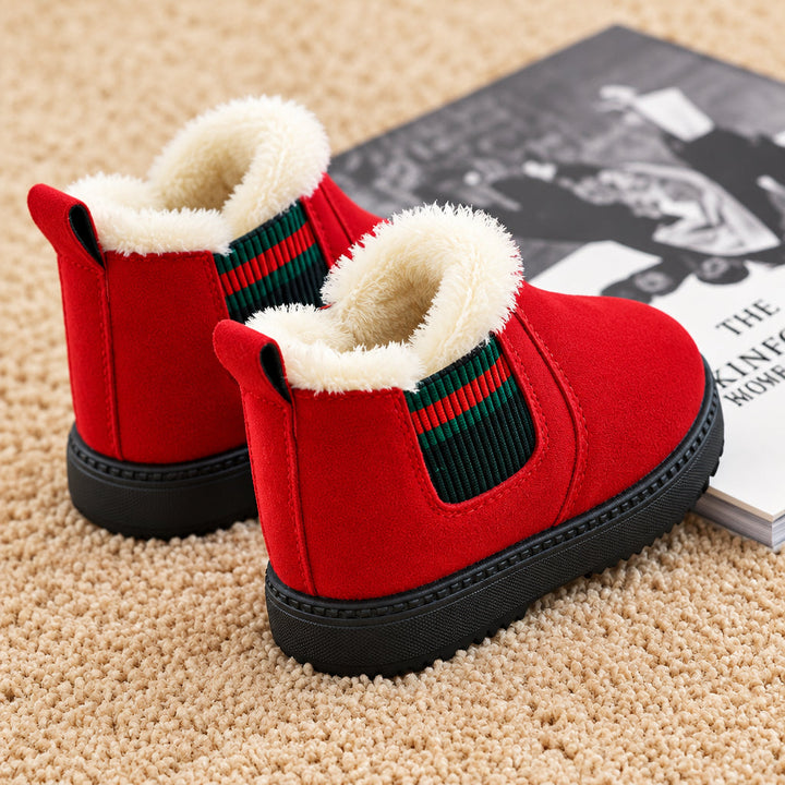 Red plush-lined winter boots showing heel pull loops and striped elastic side panels on a beige carpet.
