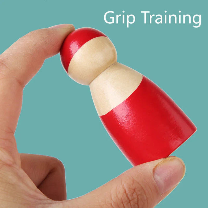 Close-up of a hand holding a red wooden sorting figure