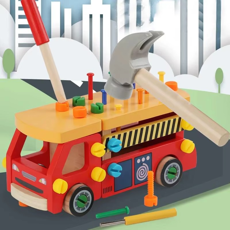 Red wooden construction truck in a play scene with a hammer and screwdriver positioned above the roof