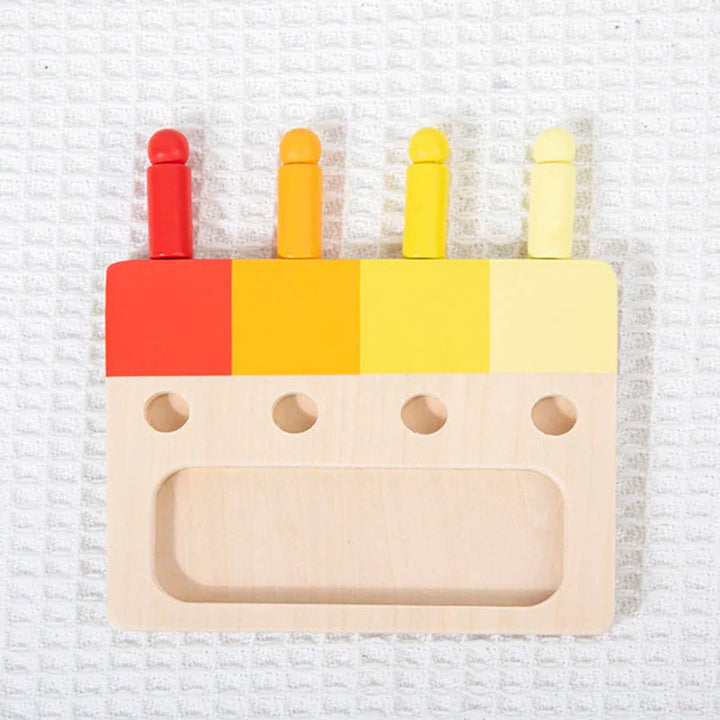 Four red and yellow wooden pegs displayed with their matching color board