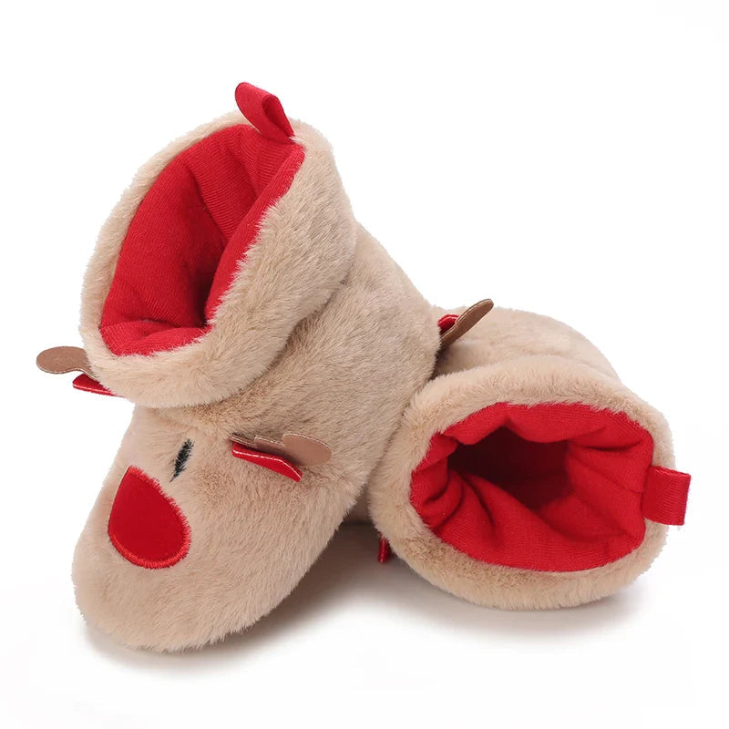 Tan reindeer baby booties tilted to show their red interiors and plush cuffs