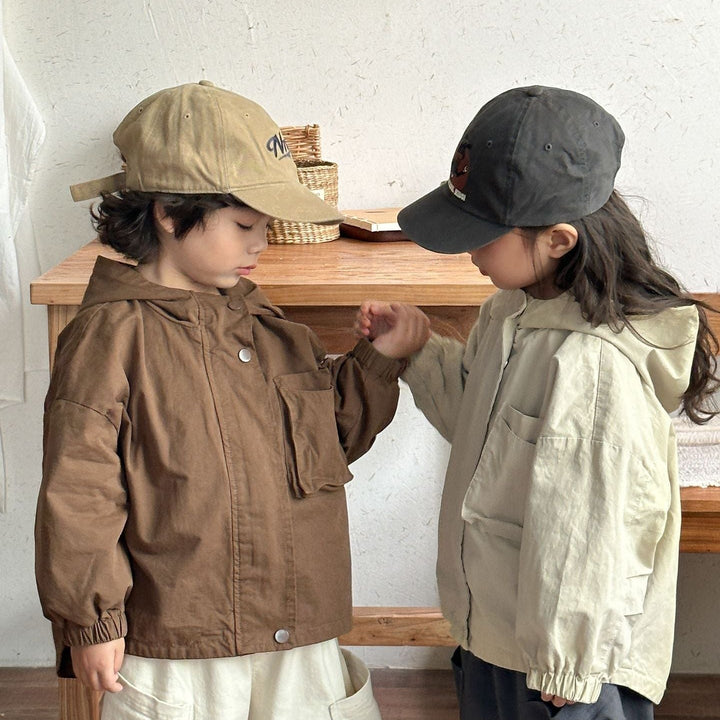 Children modeling brown and beige parkas with elastic cuffs