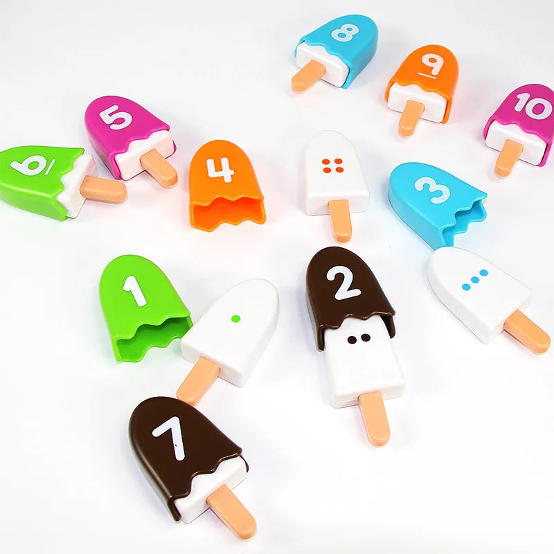 Removable numbered covers beside white popsicle pieces with colored counting dots