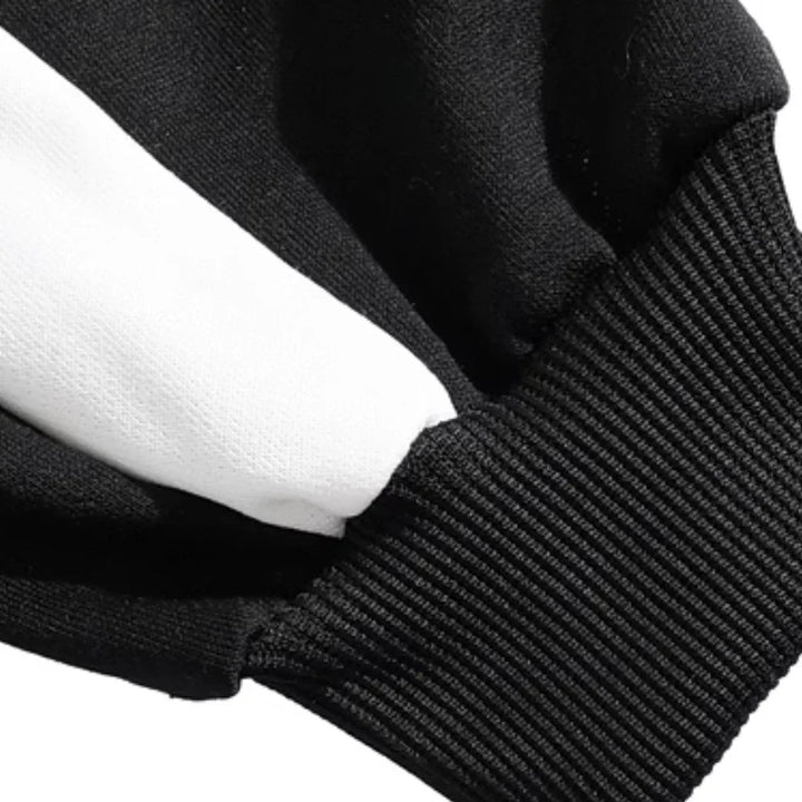 Close-up of a ribbed black cuff beside the sweater&