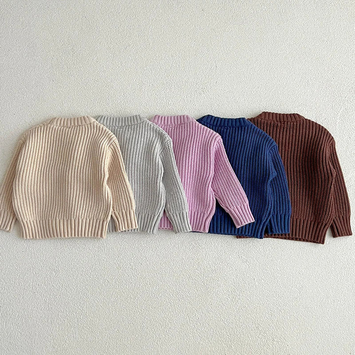 Back views of apricot, gray, purple, dark blue, and brown ribbed knit sweaters.