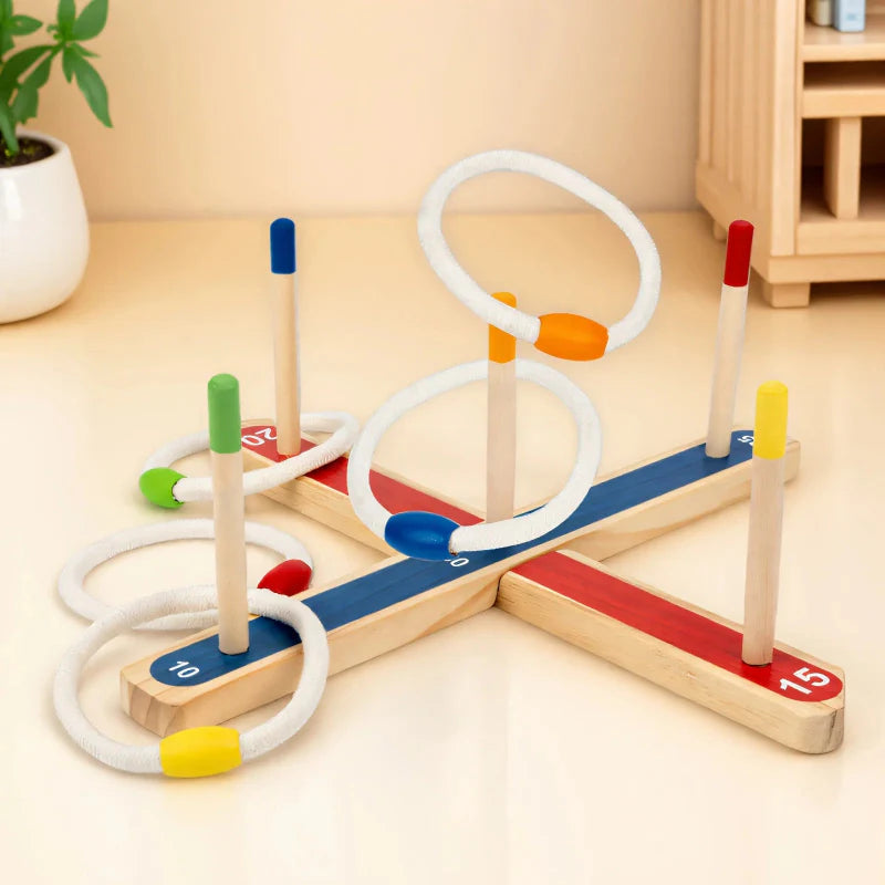 Ring toss game on a light tabletop with white rings and color-tipped wooden pegs.