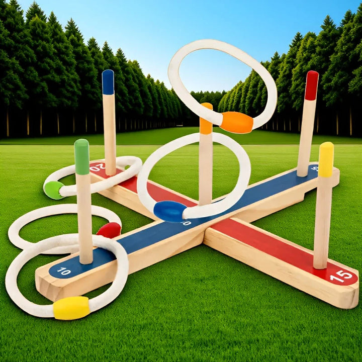Wooden ring toss set displayed on grass with colorful peg tips and white rings.