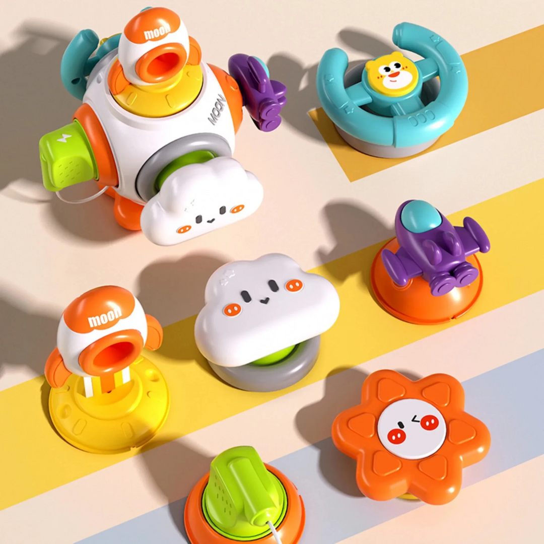 Rocket activity toy with steering wheel, cloud button, spaceship, flower, plug, and rocket panels displayed