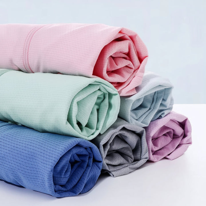 Rolled lightweight jackets in pink, mint green, light blue, blue, gray, and lavender.