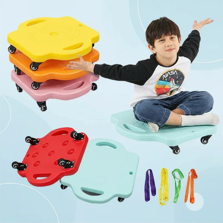 Child seated on a pale blue scooter board beside stacked boards, caster wheels, and colorful pull ropes