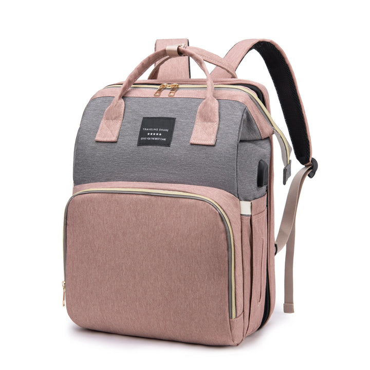 Angled front view of a pink and gray diaper backpack with shoulder straps.