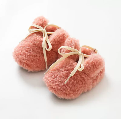 Rose gold plush bunny slippers with cream bows and small ears