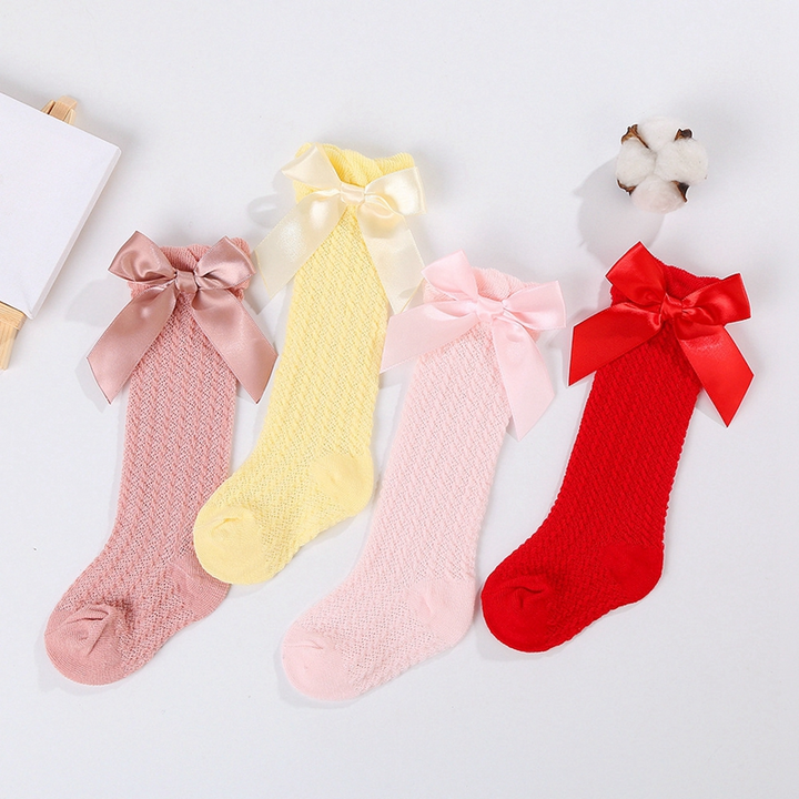 Dusty rose, yellow, pink, and red knee-high socks with satin bows