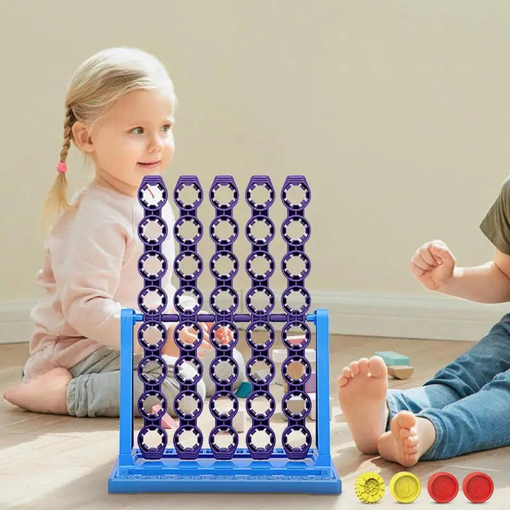 Rotating-column game set up between two children with red and yellow discs beside the base.