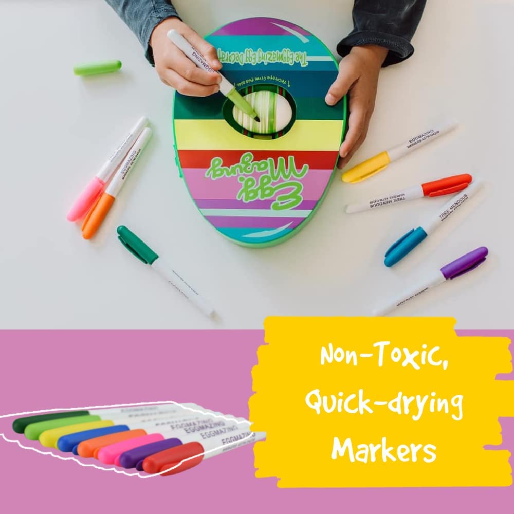 A hand draws green stripes on an egg in the rotating decorator, with colored pens shown below