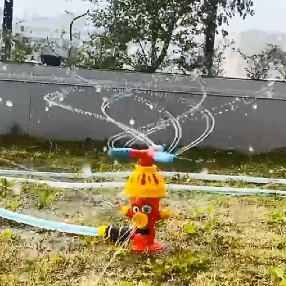 Rotating hydrant sprinkler spraying arcs of water across the grass