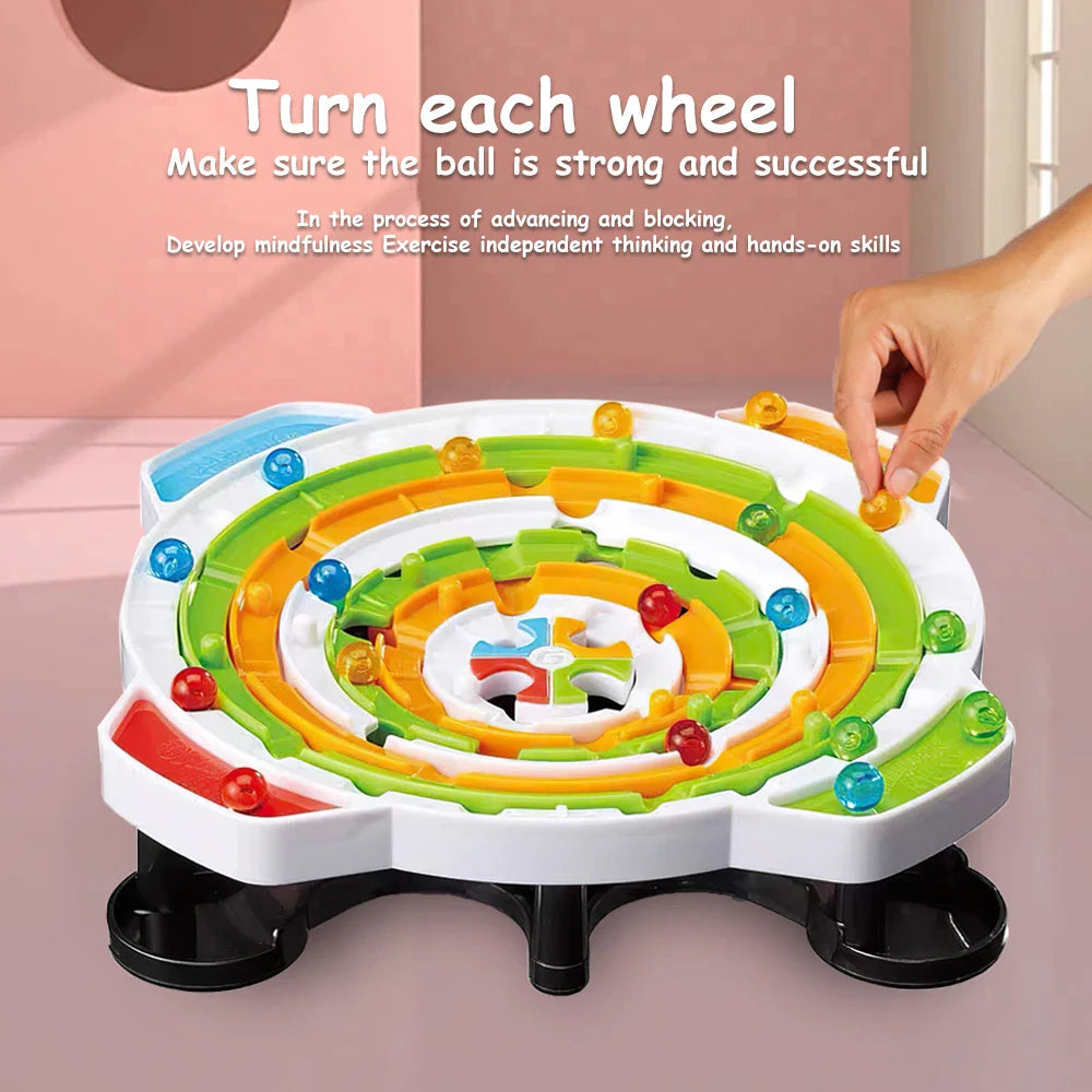 Hand reaching toward a yellow ball on the rotating ring maze game.