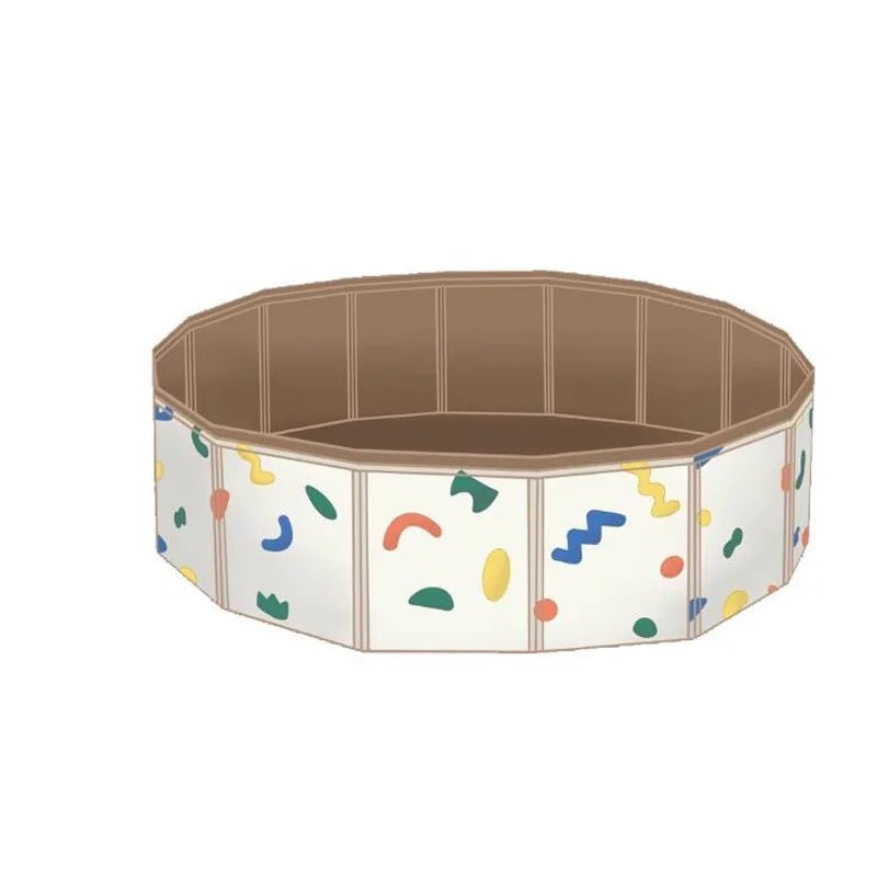 Empty round play pool with a beige interior and colorful abstract shapes on the sides