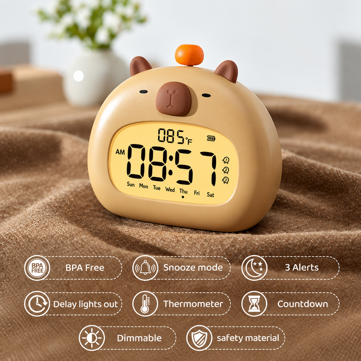 Rounded capybara alarm clock on a fabric-covered table with feature icons below.