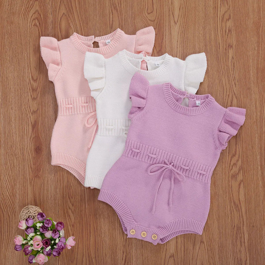 Pink, white, and light purple knit baby rompers with ruffled sleeves