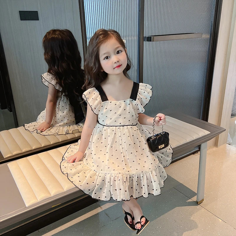 Front view of the cream heart-print dress with a square neckline and gathered skirt