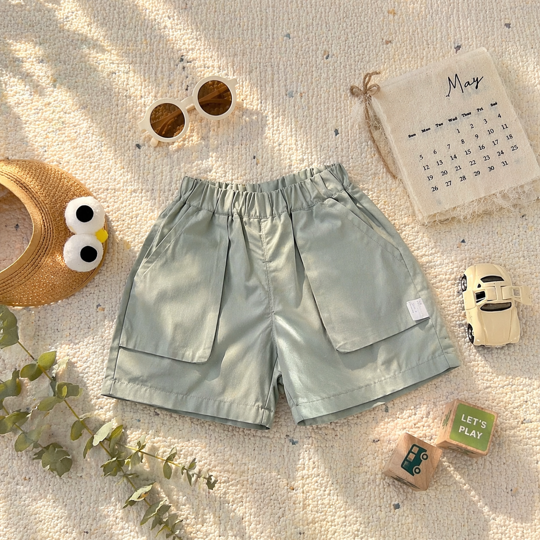 Sage green pull-on shorts with an elastic waist and roomy front patch pockets.