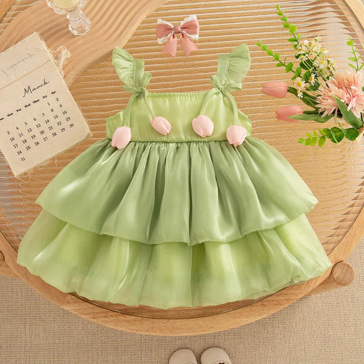 Sage green tulip dress with a tiered mesh skirt and pink floral accents
