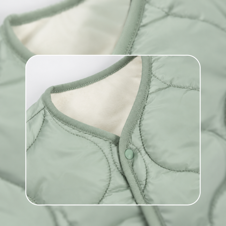 Close-up of a sage green baby vest&