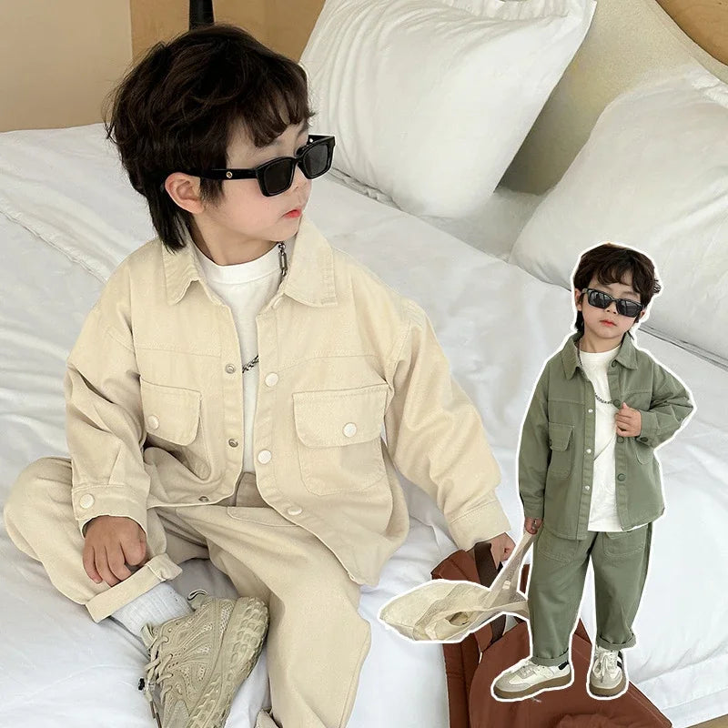 Child seated in a sand beige cargo set, with an inset view of the sage green outfit
