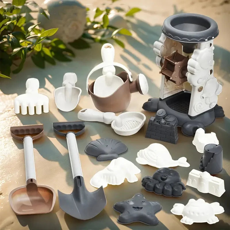 Sand mill, watering can, shovels, hand tools, and sea-creature molds arranged on sand