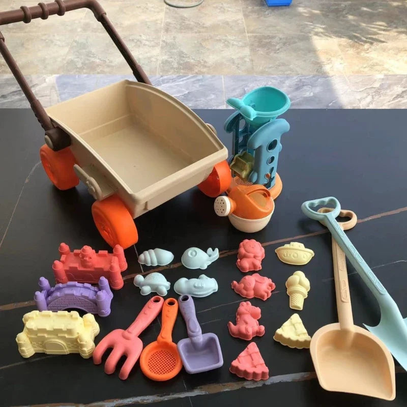 Front view of the beach wagon with watering can, sand wheel, shovels and molds laid out