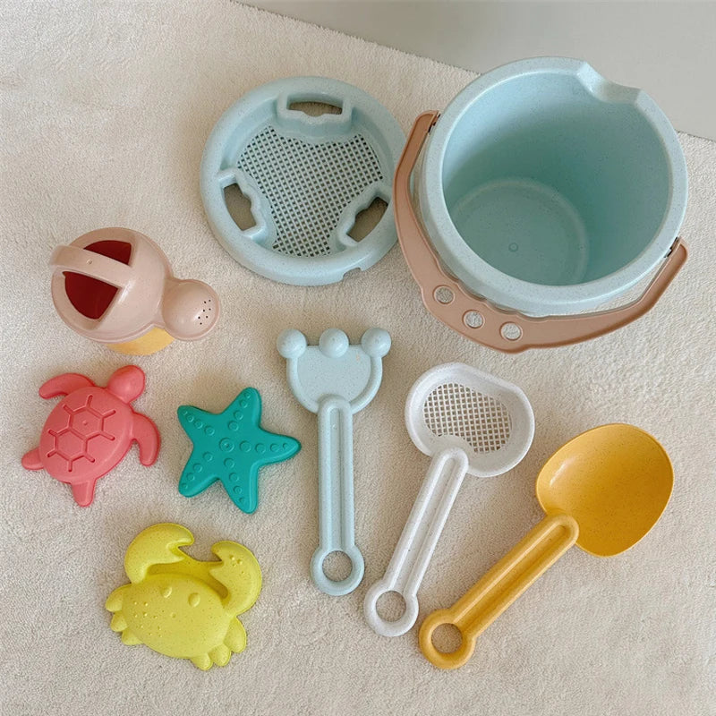 Beach bucket, watering can, turtle, starfish, and crab molds with assorted sand tools