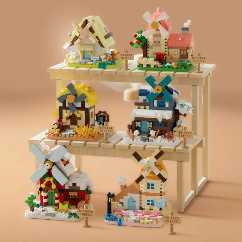 Six completed windmill building-block models in seasonal colors arranged on a tiered stand.