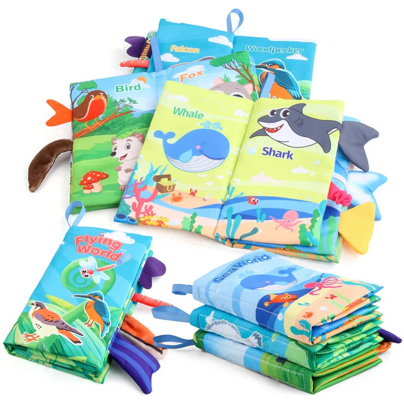 Animal-themed fabric books with a whale-and-shark spread, colorful tabs, and stacked designs.