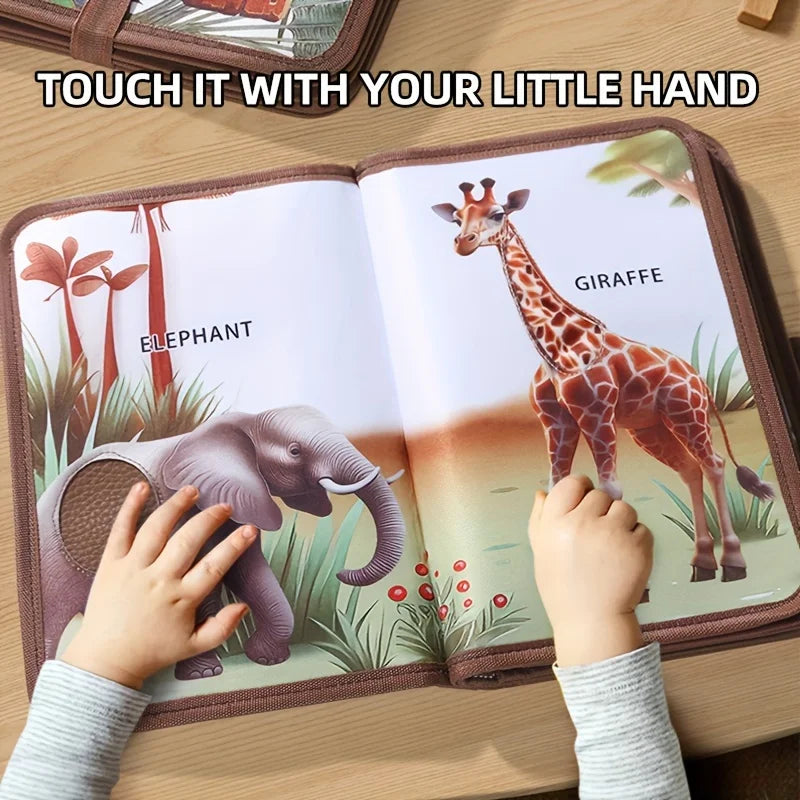 Child touching textured panels on the elephant and giraffe pages of an animal sensory book.