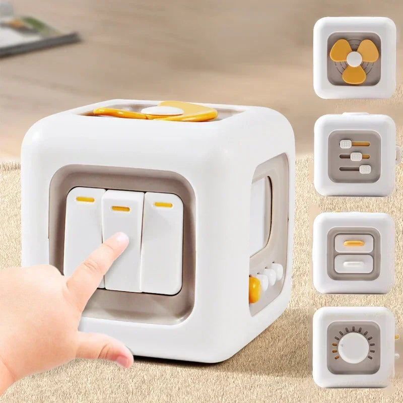 White sensory cube with yellow accents, three press switches, and close-ups of its side activities