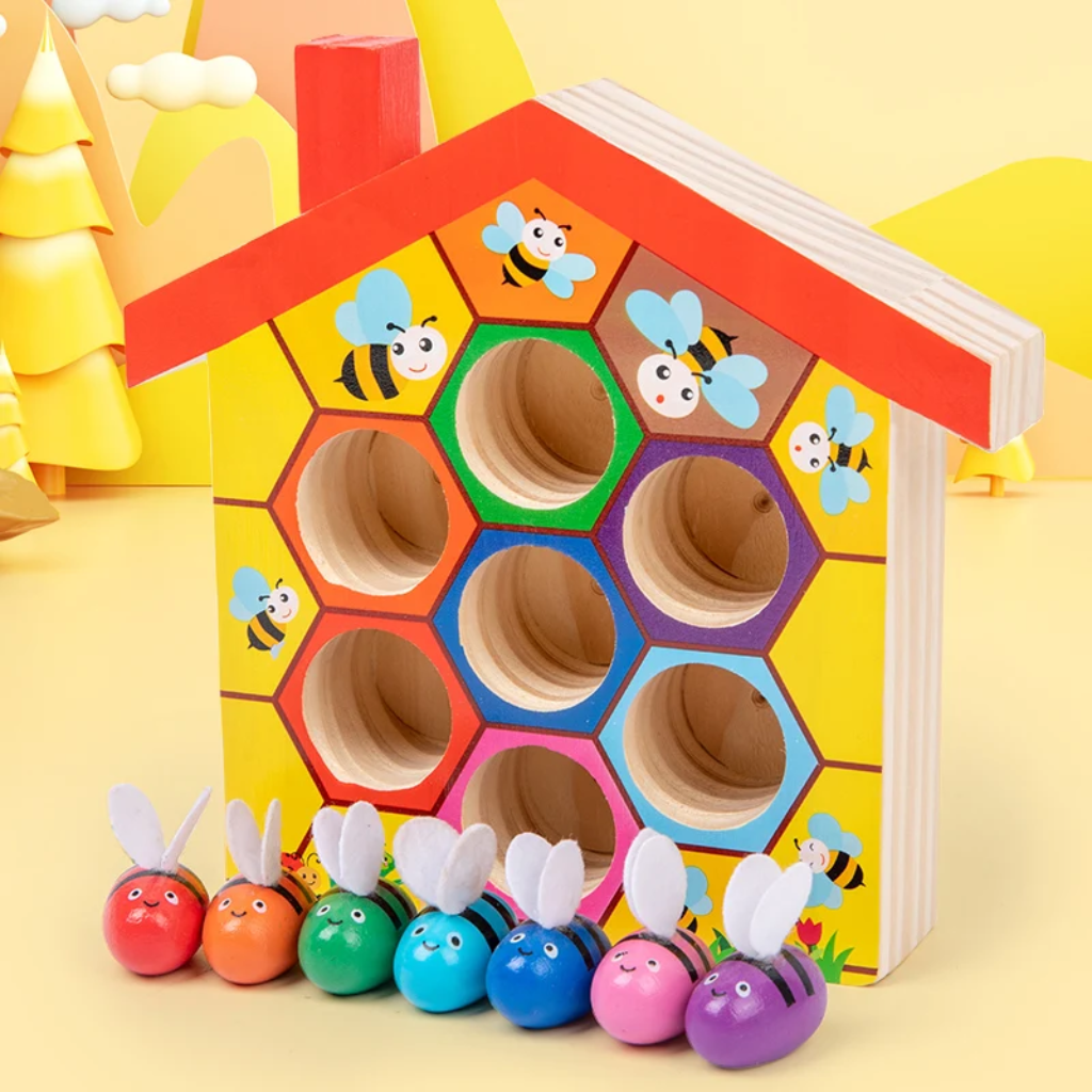 Seven colorful bees lined up beneath a wooden hive with matching colored openings