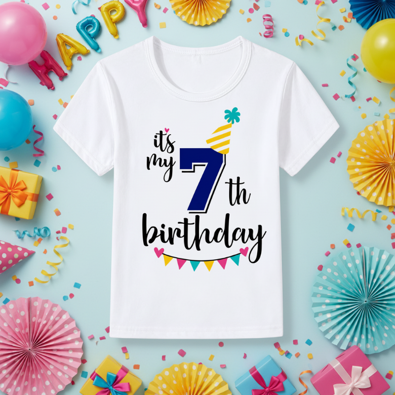 White seventh-birthday T-shirt with a blue number 7, yellow party hat, and colorful bunting