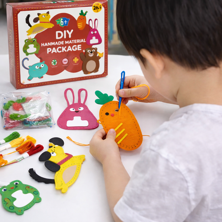 Child stitching an orange felt carrot with other felt designs on the table