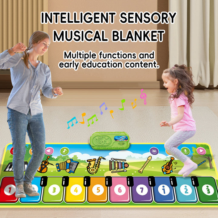 Adult and child dancing on a green musical mat with colorful numbered keys