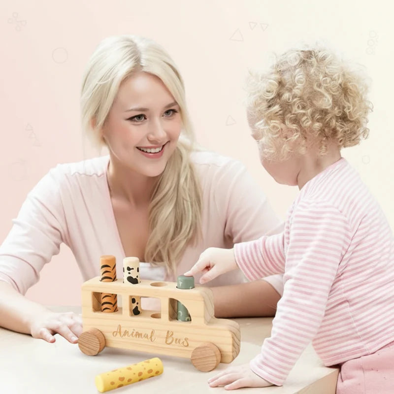 Adult and child playing together with a wooden pop-up bus