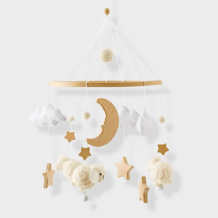 Sheep baby mobile with a wooden crescent moon, stars, white clouds, and cream-colored sheep