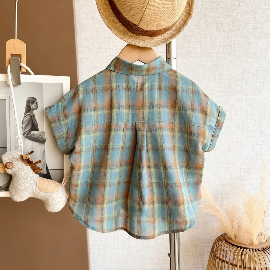 Back of the blue plaid short-sleeve shirt hanging on display