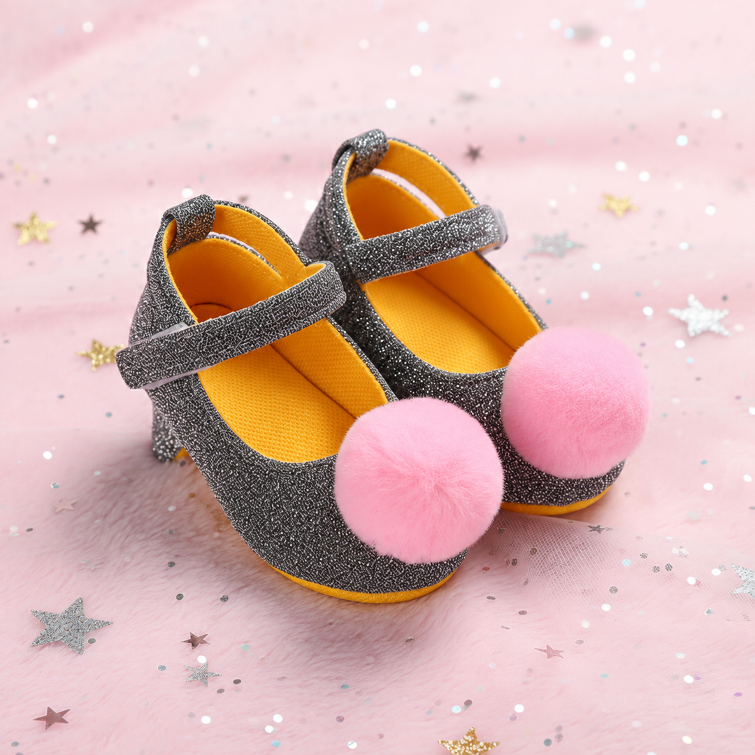 Silver glitter baby shoes with pink pom-poms and straps